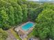 Aerial shot of a community pool surrounded by lush trees and a parking lot at 1039 Megan Ct, Sugar Hill, GA 30518