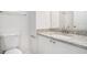 Bathroom featuring granite countertop, mirror, sink, and toilet at 277 Ralph David Abernathy Sw Blvd, Atlanta, GA 30312