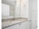 Bathroom features a granite countertop, white cabinetry, and a shower/tub combo at 277 Ralph David Abernathy Sw Blvd, Atlanta, GA 30312