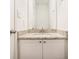 Bathroom vanity features granite countertop, mirror and white cabinetry at 277 Ralph David Abernathy Sw Blvd, Atlanta, GA 30312