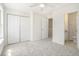 Bright bedroom with carpet, ceiling fan, closet, and ensuite bathroom with marble countertop at 277 Ralph David Abernathy Sw Blvd, Atlanta, GA 30312