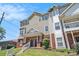 Exterior view of a multi-story home with brick accents, a well-manicured lawn, and a welcoming entrance at 277 Ralph David Abernathy Sw Blvd, Atlanta, GA 30312