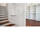 Hallway and staircase with white walls, an arched niche, and hardwood floors, leading to another room at 277 Ralph David Abernathy Sw Blvd, Atlanta, GA 30312