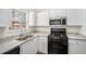 Well-lit kitchen with white cabinets, granite countertops, stainless steel appliances, and a view from the window at 277 Ralph David Abernathy Sw Blvd, Atlanta, GA 30312