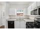 Bright kitchen featuring white cabinets and stainless appliances at 277 Ralph David Abernathy Sw Blvd, Atlanta, GA 30312