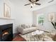 Bright living room featuring a fireplace, ceiling fan, neutral paint, and a large window for natural light at 277 Ralph David Abernathy Sw Blvd, Atlanta, GA 30312