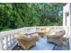 Balcony with wicker furniture, overlooks the lawn, surrounded by mature trees, for relaxing outdoor enjoyment at 4670 Hamden Forest Sw Dr, Atlanta, GA 30331