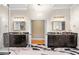 Spacious bathroom with dual vanities featuring dark cabinets, marble countertops, and stylish fixtures on decorative marble floors at 4670 Hamden Forest Sw Dr, Atlanta, GA 30331