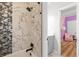 Bathroom with marble-like tiling in the shower and a view into a bedroom at 4670 Hamden Forest Sw Dr, Atlanta, GA 30331