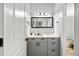 Bathroom featuring gray cabinets with a long, rectangular mirror and a view into the bedroom at 4670 Hamden Forest Sw Dr, Atlanta, GA 30331