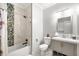 Cozy bathroom with a shower-tub combo, a marble tile accent wall, and a vanity with cabinet storage space at 4670 Hamden Forest Sw Dr, Atlanta, GA 30331
