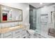 Bathroom featuring a granite countertop, white cabinetry, and a glass-enclosed shower with marble tile surround at 4670 Hamden Forest Sw Dr, Atlanta, GA 30331
