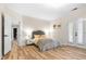 Comfortable bedroom with hardwood floors, a plush bed, and double doors leading to the outside, and an attached bath at 4670 Hamden Forest Sw Dr, Atlanta, GA 30331