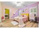 Bedroom with unique coloring, with a yellow bed, desk, and pink rug at 4670 Hamden Forest Sw Dr, Atlanta, GA 30331