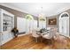 Elegant dining room with hardwood floors, chandelier lighting, and large windows with shutter blinds at 4670 Hamden Forest Sw Dr, Atlanta, GA 30331