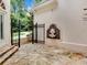 Courtyard featuring stone flooring, a water fountain, and iron gate entrance to the property at 4670 Hamden Forest Sw Dr, Atlanta, GA 30331