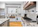 Modern kitchen featuring stainless steel appliances, granite countertops and a copper farmhouse sink at 4670 Hamden Forest Sw Dr, Atlanta, GA 30331