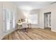 Bright office space with hardwood floors, a white desk, and large windows with double doors providing outdoor access at 4670 Hamden Forest Sw Dr, Atlanta, GA 30331