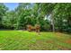 Expansive backyard featuring a wooden playset, ideal for Gathering enjoyment and outdoor activities at 5610 N Allen Rd, Mableton, GA 30126