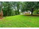 Lush backyard with a wooden playset and a deck, great for outdoor living and entertainment at 5610 N Allen Rd, Mableton, GA 30126