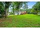 A lush backyard, perfect for outdoor enjoyment, with a well-maintained lawn and mature trees at 5610 N Allen Rd, Mableton, GA 30126