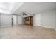Spacious basement with tile flooring, recessed lighting, and a storage unit with glass doors at 5610 N Allen Rd, Mableton, GA 30126