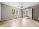 Bright bedroom featuring hardwood floors, a ceiling fan, and a mirrored closet at 5610 N Allen Rd, Mableton, GA 30126