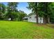 Well-maintained home with a sprawling green lawn, complemented by mature trees and a welcoming front porch at 5610 N Allen Rd, Mableton, GA 30126