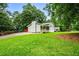Charming home with a well-manicured front yard, mature trees, and a welcoming front porch at 5610 N Allen Rd, Mableton, GA 30126