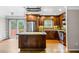 Open kitchen with stainless steel appliances, island, cabinets, and a sliding glass door at 5610 N Allen Rd, Mableton, GA 30126