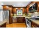 Well-equipped kitchen with stainless steel appliances, granite countertops, and wooden cabinets at 5610 N Allen Rd, Mableton, GA 30126