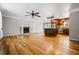 Open concept living space with hardwood floors, fireplace, and adjacent kitchen at 5610 N Allen Rd, Mableton, GA 30126