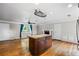 Open-concept living room with hardwood floors, fireplace, and kitchen island, perfect for modern living at 5610 N Allen Rd, Mableton, GA 30126