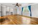 Bright living room featuring hardwood floors, staircase, and large window with curtains at 5610 N Allen Rd, Mableton, GA 30126
