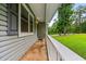 Inviting porch with white railing, offering a tranquil outdoor space and neighborhood views at 5610 N Allen Rd, Mableton, GA 30126