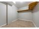 Basement storage space featuring tile flooring, a shelf, and utility connections at 5610 N Allen Rd, Mableton, GA 30126