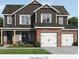 Charming two-story home with a brick and gray facade, complemented by a well-manicured lawn and a two-car garage at 214 Villa Rica Spgs, Villa Rica, GA 30180