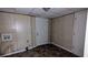 Unfinished basement with wood paneling, tile flooring, and a white exterior door at 2168 Sara Ashley Way, Lithonia, GA 30058
