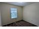 Cozy bedroom with neutral walls, plush carpeting, and a window with blinds at 2168 Sara Ashley Way, Lithonia, GA 30058