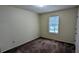 Simple bedroom features carpet, a window letting in natural light, and neutral colored walls at 2168 Sara Ashley Way, Lithonia, GA 30058