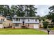 Split-level home boasts stone accents, a front porch, attached garage, and a well-manicured front lawn at 2168 Sara Ashley Way, Lithonia, GA 30058