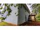 View of home's blue siding and outdoor staircase leading to a deck in a wooded backyard at 2168 Sara Ashley Way, Lithonia, GA 30058