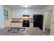 Updated kitchen featuring stainless steel appliances, granite countertops, and ample cabinet space at 2168 Sara Ashley Way, Lithonia, GA 30058