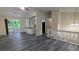 Open-concept living area with hardwood floors, updated lighting, and access to the kitchen and outdoor deck at 2168 Sara Ashley Way, Lithonia, GA 30058