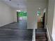 Open-concept living space featuring modern flooring, a sliding glass door to the deck, and access to the kitchen at 2168 Sara Ashley Way, Lithonia, GA 30058