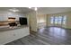 Living area with hardwood floors open to kitchen with stainless appliances and granite countertops at 2168 Sara Ashley Way, Lithonia, GA 30058