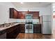Well-equipped kitchen featuring stainless steel appliances and dark wood cabinetry at 3155 Tarian Way, Decatur, GA 30034