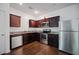 Modern kitchen with stainless steel appliances, granite countertops, and dark wood cabinetry at 3155 Tarian Way, Decatur, GA 30034