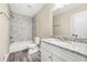 Updated bathroom featuring modern fixtures, granite counters, and a beautifully tiled shower and tub at 3521 Brookhill Cir, Marietta, GA 30062