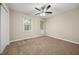 Cozy bedroom featuring plush carpeting, a ceiling fan, and bright natural light at 3521 Brookhill Cir, Marietta, GA 30062